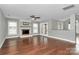 Spacious living room featuring a fireplace, hardwood floors, and access to the backyard at 2321 Heathershire Ln, Matthews, NC 28105