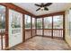 Screened-in porch with wood floor and white railings overlooking the backyard at 2321 Heathershire Ln, Matthews, NC 28105