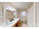 Bright bathroom features double sinks, tile floor, and natural light from a window at 2360 Kings Grant Rd, Lincolnton, NC 28092