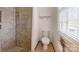 Updated bathroom with tiled shower, toilet and window offering natural light at 2360 Kings Grant Rd, Lincolnton, NC 28092