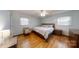 A serene bedroom with hardwood floors, neutral colors, and a cozy seating area by the window at 2360 Kings Grant Rd, Lincolnton, NC 28092