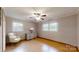 Bedroom featuring hardwood floors, a chair, two windows offering natural light, and a calm atmosphere at 2360 Kings Grant Rd, Lincolnton, NC 28092