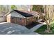 This brick home has a side entrance and a large concrete driveway at 2360 Kings Grant Rd, Lincolnton, NC 28092