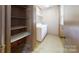 Convenient laundry room with washer, dryer, and built-in shelving for organization and storage at 2360 Kings Grant Rd, Lincolnton, NC 28092
