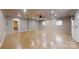 Expansive living room features gleaming hardwood floors, recessed lighting, and multiple windows for ample sunlight at 2360 Kings Grant Rd, Lincolnton, NC 28092