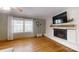 Cozy living room with a fireplace and gleaming hardwood floors at 2360 Kings Grant Rd, Lincolnton, NC 28092
