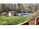 Backyard pool and poolhouse surrounded by green lawn and mature trees create a private oasis at 2360 Kings Grant Rd, Lincolnton, NC 28092