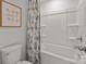 Bathroom featuring a white bathtub, white tiled walls, and patterned shower curtain at 281 Supernova Dr, York, SC 29745