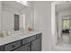 A full bathroom with white countertops, dark cabinets and a shower with a patterned shower curtain at 281 Supernova Dr, York, SC 29745
