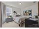 A bright bedroom featuring a large window, neutral decor and modern furnishings at 281 Supernova Dr, York, SC 29745