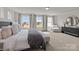 Bright main bedroom with a large bed, bench, and view of the neighborhood at 281 Supernova Dr, York, SC 29745