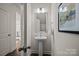 A stylish powder room featuring a pedestal sink and decorative mirror at 281 Supernova Dr, York, SC 29745