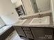 Bathroom featuring a double sink vanity with dark wood cabinets and a built-in shelf, next to a soaking tub at 339 Pine Lake Dr # 760, Troy, NC 27371