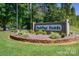 Landscaped entrance to Carolina Forest, a well-maintained community with lush greenery and signage at 339 Pine Lake Dr # 760, Troy, NC 27371