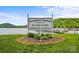 Community sign for Carolina Forest on Lake Tillery near the Clubhouse and Marina on a partly cloudy day at 339 Pine Lake Dr # 760, Troy, NC 27371