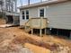 Exterior view of a newly constructed deck and the side of a home, supported by concrete blocks at 339 Pine Lake Dr # 760, Troy, NC 27371