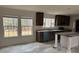 Bright kitchen with windows, dark wood cabinets, stainless steel appliances, and a charming center island at 339 Pine Lake Dr # 760, Troy, NC 27371