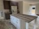 Spacious kitchen with stainless steel appliances, an island with modern countertop, and dark wood cabinets at 339 Pine Lake Dr # 760, Troy, NC 27371