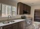 Modern kitchen with dark cabinets, granite countertops, stainless steel appliances and a large window at 339 Pine Lake Dr # 760, Troy, NC 27371