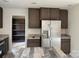 Bright kitchen featuring stainless steel refrigerator and dark wood cabinets, offering modern appeal at 339 Pine Lake Dr # 760, Troy, NC 27371