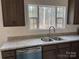 Modern kitchen with dark cabinets, granite countertops, stainless steel appliances and a large kitchen island at 339 Pine Lake Dr # 760, Troy, NC 27371