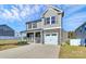 Beautiful two-story home with a two-car garage, stone accents, and a well-manicured lawn at 404 Brannon Meadows Dr # 270, York, SC 29745