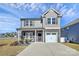 Charming two-story home with a welcoming front porch, stone accents, and a well-maintained yard at 404 Brannon Meadows Dr # 270, York, SC 29745