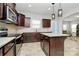 Beautiful kitchen with stainless steel appliances, granite countertops, and dark wood cabinetry at 404 Brannon Meadows Dr # 270, York, SC 29745