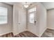Bright entryway featuring a glass-paneled front door, vinyl flooring, and a convenient coat closet at 4102 Cheyney Park Dr, Charlotte, NC 28269