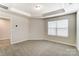 Bedroom with tray ceiling, neutral carpet, and a large window at 4118 Cheyney Park Dr, Charlotte, NC 28269