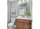 Clean bathroom features a wood vanity, modern sink, toilet, and framed artwork at 4790 Formation Ct # 67, Lancaster, SC 29720