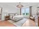 Elegant main bedroom featuring neutral tones, tray ceiling, and ample natural light from windows overlooking the yard at 4790 Formation Ct # 67, Lancaster, SC 29720