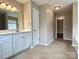 A bathroom featuring a double sink vanity and a tiled floor at 4809 Canipe Dr, Charlotte, NC 28269