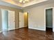 An ample bedroom featuring neutral walls and dark wood-look floors at 4809 Canipe Dr, Charlotte, NC 28269