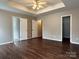 An ample bedroom featuring neutral walls and dark wood-look floors at 4809 Canipe Dr, Charlotte, NC 28269