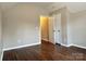 An ample bedroom featuring neutral walls and dark wood-look floors at 4809 Canipe Dr, Charlotte, NC 28269