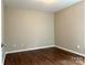 Bedroom features neutral paint, hardwood floors, base molding, and ample natural light at 4809 Canipe Dr, Charlotte, NC 28269