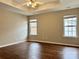A bedroom featuring neutral walls, two windows and dark wood-look floors at 4809 Canipe Dr, Charlotte, NC 28269