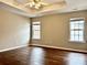 A bedroom featuring neutral walls, two windows and dark wood-look floors at 4809 Canipe Dr, Charlotte, NC 28269