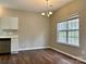 Open-concept dining area features hardwood floors, window with natural light, and adjacent kitchen space at 4809 Canipe Dr, Charlotte, NC 28269