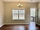 Bright dining room with hardwood floors, modern light fixture, and large window overlooking the yard at 4809 Canipe Dr, Charlotte, NC 28269