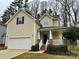 Two-story home with a well-maintained lawn, attached garage, and welcoming front porch at 4809 Canipe Dr, Charlotte, NC 28269