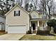 Charming two-story home with a well-maintained lawn, attached garage, and welcoming front porch at 4809 Canipe Dr, Charlotte, NC 28269