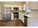 Modern kitchen with stainless steel appliances, white cabinets, and ample counter space at 4809 Canipe Dr, Charlotte, NC 28269