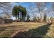 Expansive grassy backyard, shaded by mature trees, offering ample space at 517 Stockton St, Statesville, NC 28677