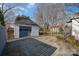 Detached garage with gray door and gravel driveway, offering convenient parking at 517 Stockton St, Statesville, NC 28677