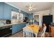 Traditional kitchen featuring blue cabinetry, vintage appliances, and brick flooring at 517 Stockton St, Statesville, NC 28677