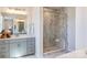 Modern bathroom with a glass-enclosed shower, gray cabinetry, double sinks, and marble accents at 5911 Wetlands Aly, Charlotte, NC 28215