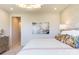 Bedroom with a large picture above the bed, a modern light fixture, and a view into the hallway at 5911 Wetlands Aly, Charlotte, NC 28215