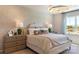 Comfortable bedroom with neutral tones, decorative wallpaper, bedside tables, and a stylish light fixture at 5911 Wetlands Aly, Charlotte, NC 28215